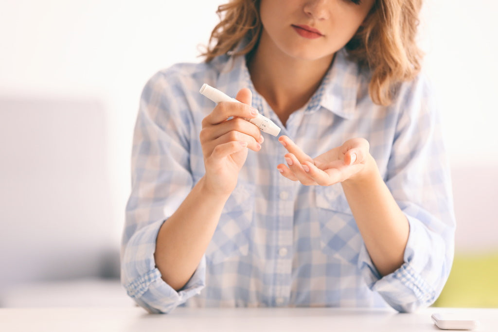 Diabetes Typ 1: Junge Frau misst ihren Blutzucker